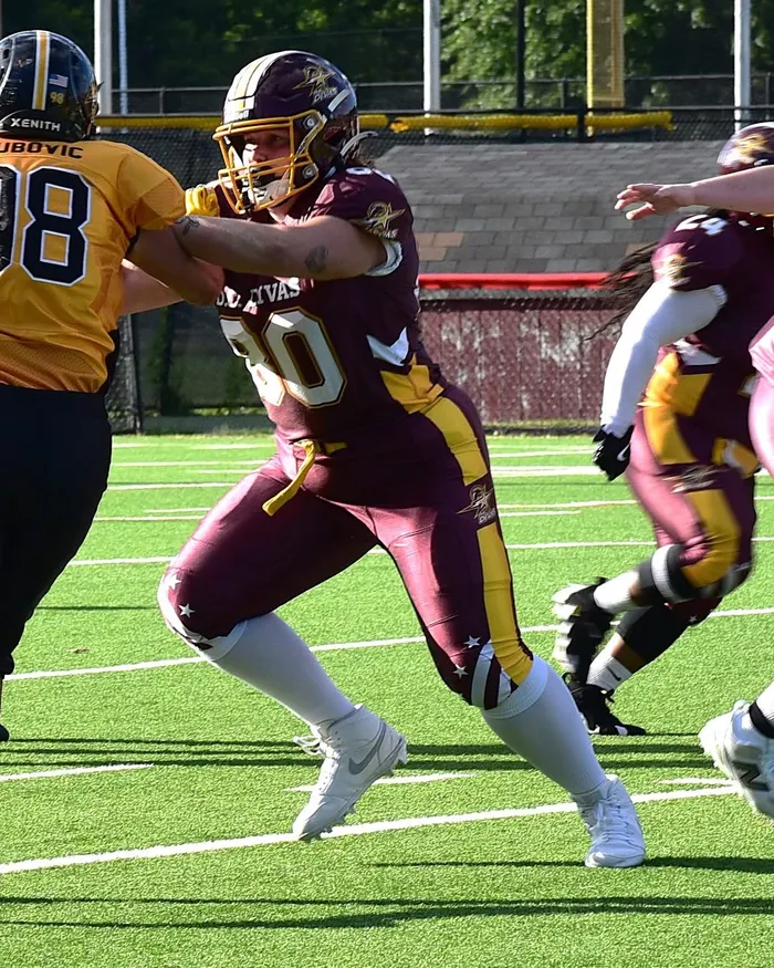 Anna, number 90 for the D.C. Divas, blocking an opponent during a game