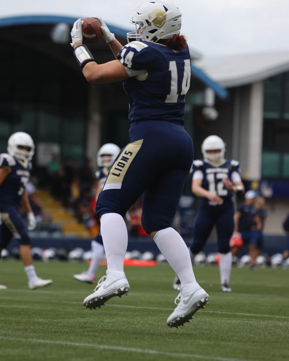Anna catching an American football while playing for Great Britain